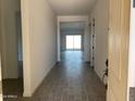 Bright entryway featuring neutral walls and stylish gray wood-look tile flooring at 31512 N Hayweather Ln, San Tan Valley, AZ 85143