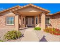 Inviting front porch with decorative door, manicured plants, and well-maintained landscaping at 3408 W Taro Ln, Phoenix, AZ 85027