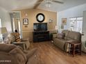 Comfortable living room with recliner seating, a fireplace, and wood laminate flooring at 4065 E University Dr # 556, Mesa, AZ 85205