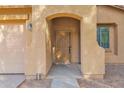 Inviting covered front porch with stone accents providing shelter from the elements at 43524 W Bailey Dr, Maricopa, AZ 85138