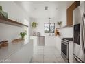 Bright, modern kitchen with white cabinets, marble floors, and stainless steel appliances at 6114 N 8Th St, Phoenix, AZ 85014