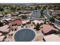 Aerial view of a desert community shows the street and well manicured lawns, as well as desert landscaping at 6450 S Windstream Pl, Chandler, AZ 85249