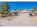 Charming single-story home boasts a well-maintained yard and a spacious two-car garage at 6450 S Windstream Pl, Chandler, AZ 85249
