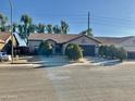 Single-story home with landscaped front yard, two-car garage, and desert landscaping at 7551 W Pasadena Ave, Glendale, AZ 85303