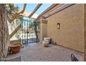 Courtyard with brick flooring, outdoor decor, and a wrought iron security gate at 8151 E Del Joya Dr, Scottsdale, AZ 85258