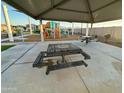 Community playground featuring a covered picnic area with tables and benches, ideal for Gathering gatherings at 9745 W Agora Ln, Tolleson, AZ 85353