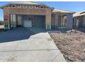 An in-progress construction site shows the skeleton of a wood framed structure including garage and concrete driveway at 1317 S Vista Ave, Florence, AZ 85132