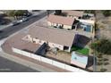 Aerial view of a single-Gathering home with fenced backyard and desert landscaping at 1624 W Minton St, Phoenix, AZ 85041