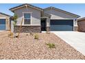 Charming home with a two-car garage, stone accents, and low maintenance landscaping at 17434 W Eva St, Waddell, AZ 85355