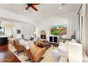 Bright and inviting living room with a fireplace, large TV, comfortable seating, and view into the kitchen at 18650 N Thompson Peak Pkwy # 1028, Scottsdale, AZ 85255