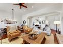 Well-lit living room and dining area with an open-concept design, neutral colors, and stylish décor and furniture at 18650 N Thompson Peak Pkwy # 1028, Scottsdale, AZ 85255