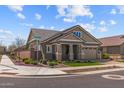 Charming single-Gathering home featuring attractive landscaping and stone accents on a corner lot at 23161 E Mockingbird Dr, Queen Creek, AZ 85142