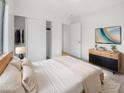 Bright bedroom with a modern platform bed, stylish dresser, and a closet with sliding doors at 29219 N Red Finch Dr, San Tan Valley, AZ 85143