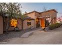 Gorgeous front exterior featuring desert landscaping, stone pathway, and stunning architecture that adds character to the residence at 3086 N Herrala Way, Apache Junction, AZ 85119