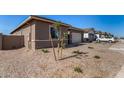Exterior view of a new construction home featuring low maintenance desert landscaping at 31476 N Hayweather Ln, San Tan Valley, AZ 85143
