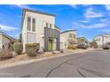 Contemporary two-story home featuring modern architecture, neutral stucco exterior, and low-maintenance desert landscaping at 367 N 157Th Ln, Goodyear, AZ 85338