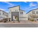 Contemporary two-story home featuring modern architecture, neutral stucco exterior, and low-maintenance desert landscaping at 367 N 157Th Ln, Goodyear, AZ 85338