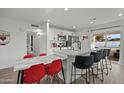 Bright kitchen featuring stainless steel appliances, white cabinets, a large island with seating, and access to the backyard at 7407 E Polk St, Scottsdale, AZ 85257