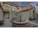 Exterior shot of a tan building with a charming cactus garden in the courtyard at 7675 E Mcdonald Dr # 222, Scottsdale, AZ 85250