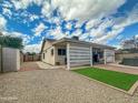 Well-kept backyard with gravel, artificial turf, and covered patio, ideal for relaxation and outdoor enjoyment at 8611 W Village Dr, Peoria, AZ 85382