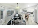 Bright kitchen with white cabinets, modern appliances, and a spacious dining area with great natural light at 8611 W Village Dr, Peoria, AZ 85382