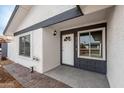 Inviting front entrance featuring a well-lit porch and a stylish front door with sidelights and a window at 8920 N 56Th Ave, Glendale, AZ 85302