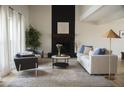 Bright living room showcasing a fireplace, comfortable seating, and stylish decor, creating an inviting and cozy atmosphere at 971 E Driftwood Dr, Tempe, AZ 85283
