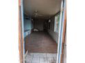 View of the living room from the porch area with wooden floors and unfinished walls at 9716 E Birchwood Ave, Mesa, AZ 85208