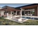 Beautiful backyard with a pool, patio, and fire pit that provides a seamless transition to indoor/outdoor living at 9790 N 56Th St, Paradise Valley, AZ 85253