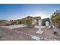 View of home's exterior featuring a gravel yard and private water system at 12326 N Lang Rd, Florence, AZ 85132