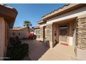 Inviting front porch featuring stone accents and a security door, surrounded by desert landscaping at 15712 W Eucalyptus Ct, Surprise, AZ 85374