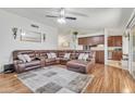 Spacious living room featuring a large sectional sofa, wood floors, and access to the kitchen at 19061 N 5Th Ave, Phoenix, AZ 85027