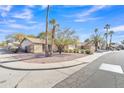 Neighborhood street showcasing well-kept homes with desert landscaping and mature palm trees at 19061 N 5Th Ave, Phoenix, AZ 85027