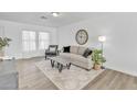 Comfortable living area with a neutral color palette, hardwood floors, and a large window for natural light at 197 E Douglas Ave, Coolidge, AZ 85128