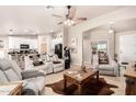 Open-concept living space with tile flooring, neutral tones, and comfortable, modern furniture, perfect for entertaining at 20438 W Carver Rd, Buckeye, AZ 85326
