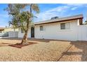 Exterior view of house with gravel landscaping and mature trees at 2053 W Pecan Rd, Phoenix, AZ 85041