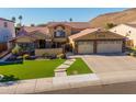 Inviting two-story home with well-manicured lawn, stone accents, and a spacious three-car garage at 21666 N 53Rd Dr, Glendale, AZ 85308