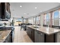 Bright, open kitchen with granite countertops, stainless appliances, and a view into the dining and living area at 2466 E Rosario Mission Dr, Casa Grande, AZ 85194