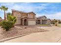 Charming two-story home with a two-car garage and desert landscaping at 2551 E Kent Ave, Gilbert, AZ 85296