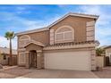 Charming two-story home with a two-car garage and desert landscaping at 2551 E Kent Ave, Gilbert, AZ 85296