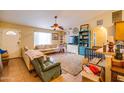 Inviting living room with a ceiling fan, tile flooring, and lots of natural light coming in at 26631 S Lime Dr, Queen Creek, AZ 85142