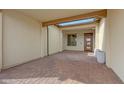 Covered patio featuring brick pavers, a skylight, and a stylish front door at 29348 N Clear Ridge Rd, Rio Verde, AZ 85263