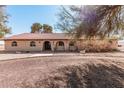 Inviting single-story house with a tile roof, arched doorways, and desert landscaping at 3279 E Selma Hwy, Casa Grande, AZ 85194