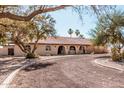 Charming single-story home featuring a tile roof, arched entryways, and well-maintained landscaping at 3279 E Selma Hwy, Casa Grande, AZ 85194