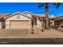 Inviting single-story home with desert landscaping, a two-car garage, and mature trees at 3354 N 157Th Ave, Goodyear, AZ 85395