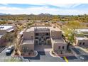 Aerial view of desert home showcasing a private courtyard, and easy access to nearby amenities and the highway at 36601 N Mule Train Rd # D30, Carefree, AZ 85377