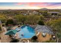 Aerial view of a luxury pool with a spa, swim up bar, and desert views at 37080 N 109Th Way, Scottsdale, AZ 85262