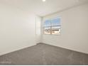 Neutral bedroom with carpet, a window with blinds, and a closet door at 37093 W La Paz St, Maricopa, AZ 85138