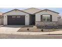 Charming single-story home with a two-car garage and desert landscaping at 37093 W La Paz St, Maricopa, AZ 85138