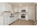 Updated kitchen with white cabinets, a farmhouse sink, and stainless steel appliances at 4307 E Turney Ave, Phoenix, AZ 85018